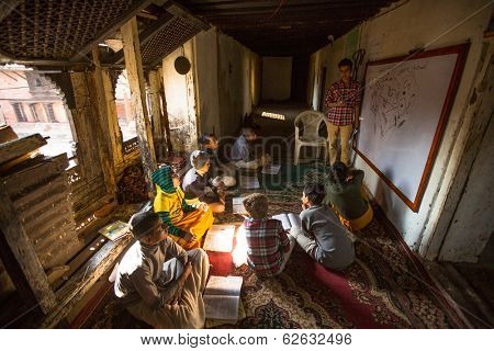 KATHMANDU, NEPAL - DEC 9, 2013: Unknown children in lesson at Jagadguru School. School established at 2013, to let new generation learn Sanskrit and preserve Hindu culture. 