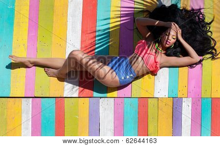 Tropical summer holiday fashion vogue concept - african american woman on a wooden pier background