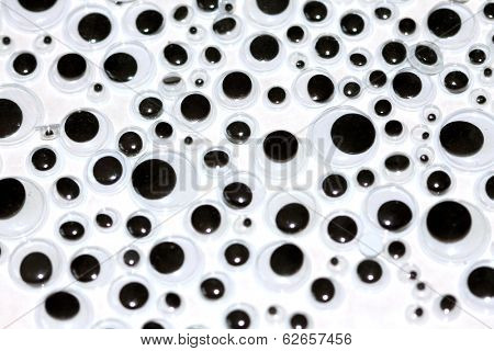 Googly eyes are small plastic craft supplies used to imitate eyeballs. Googly eyes traditionally are composed of a clear, hard-plastic shell, with a smaller, black plastic disk trapped within.