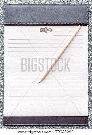 Blank Notepad With Pencil On The Brown Clipboard.