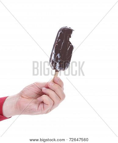 Hand holds chocolate ice cream.