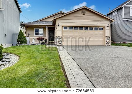 Gararge With Stone Trim And New Driveway