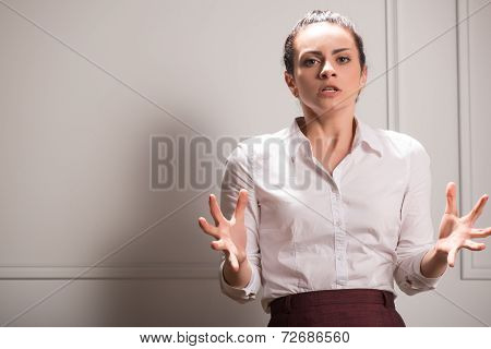 Serious woman wearing white blouse