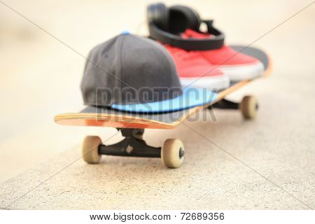 red sneakers  and hat on skateboard outdoor