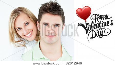 Portrait of a young happy couple standing against a white background against cute valentines message