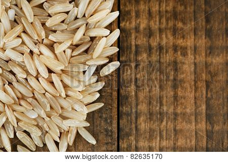 Rice grains on wooden background