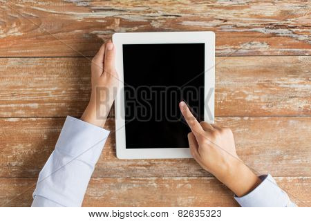 business, education, people and technology concept - close up of female hands pointing finger to tablet pc computer black blank screen on table