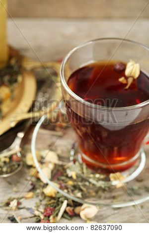 Beautiful vintage composition with herbal tea, on wooden table