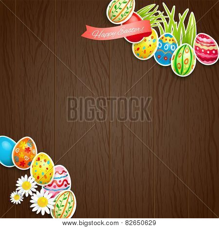Easter colored eggs on wood background with copy space.