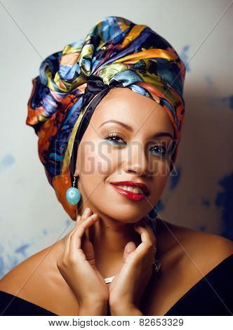 beauty bright african woman with creative make up, shawl on head
