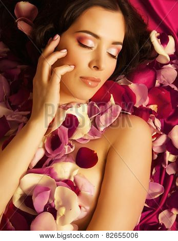 beauty young brunette woman with flower close up