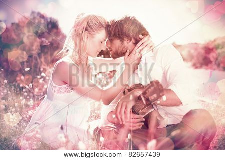 Handsome man serenading his girlfriend with guitar on a sunny day