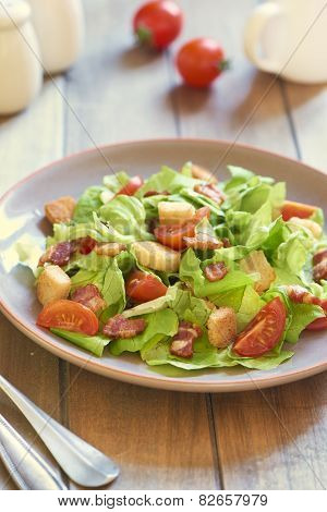 Caesar salad with smoked ham and cherry tomatoes