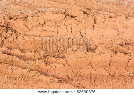 Traces of driving wheels running through on the red soil road