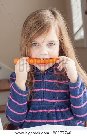 Little Girl Biting On A Carrot