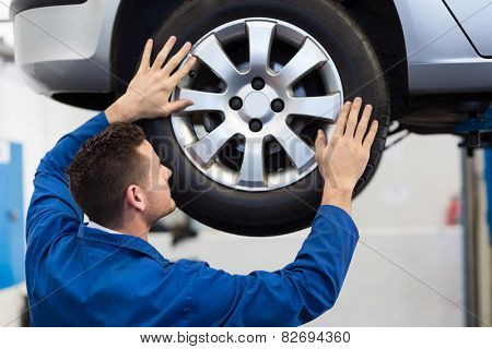 Mechanic adjusting the tire wheel at the repair garage