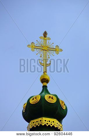 Dome Of Russian Orthodox Church With Cross Against Blue Sky
