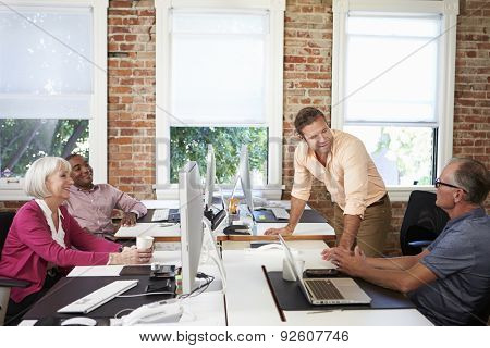 Group Of Workers At Desks In Modern Design Office