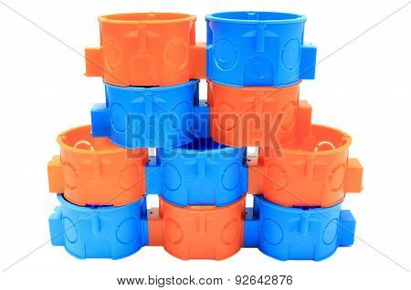 Stack Of Orange And Blue Electrical Boxes. White Background