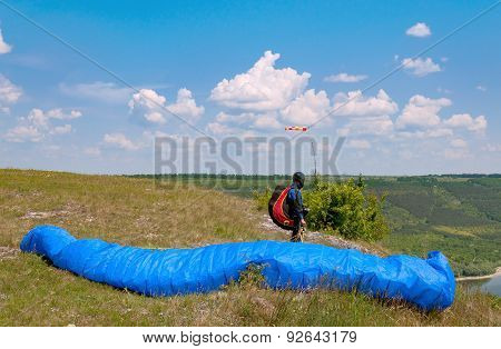 Paraglider Prepares To Fly Over Beautiful Bakota Reservoir.