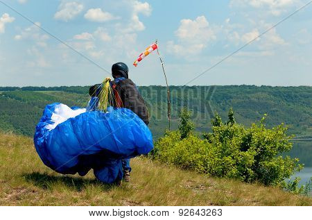 Paraglider Prepares To Fly Over Beautiful Bakota Reservoir.