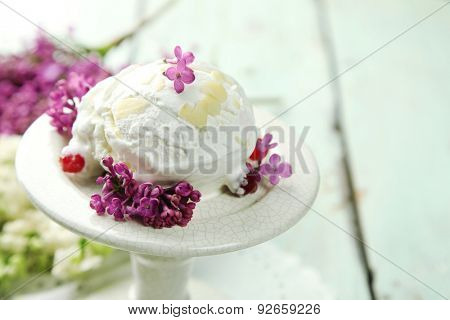 Beautiful composition with tasty ice cream and lilac flowers