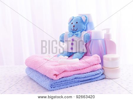 Baby accessories for bathing on table on light background
