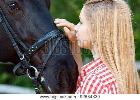 Smiling girl palming the horse