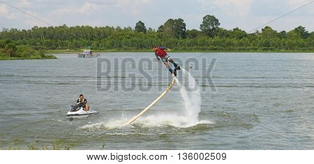 MUSEUM SERPENT KARK, YASOTHON, THAILAND - JUNE 19, 2016: Man ride on flyboard; an extreme water sport at public park.