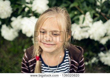 Summer. Beautiful blond girl looks away and smile.