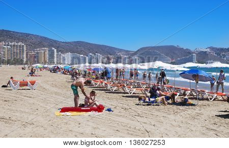 CULLERA, SPAIN - JUNE 23: Sunbathers at San Antonio Beach on June 23, 2016 in Cullera, Spain. It is the main beach in this popular tourist village in the Valencian Community