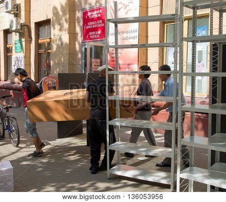 Voronezh Russia - June 03 2013 Loaders carry things on the street during an office relocation