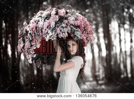 Young girl in soft light style color standing in lilac flowers. umbrella. Beautiful fashion make up. Sun shadow on face