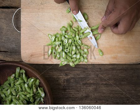 stil life yardlong bean slice on Chopping board wood.