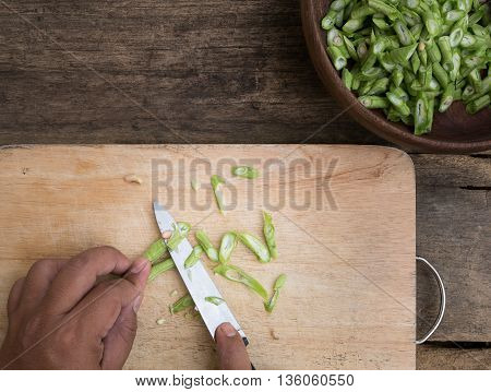 stil life yardlong bean slice on Chopping board wood.