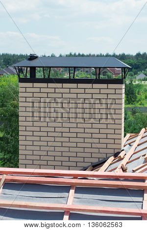 chimney with light brick newly built cottage with no roof tiles