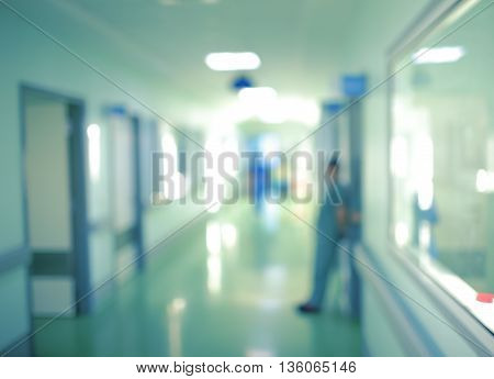 Workers silhouette in hospital corridor unfocused background.