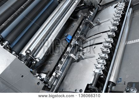 Offset printing press in printery. Close-up photo