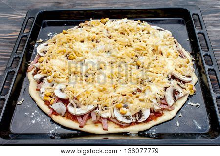 Pizza prepared to bake in the oven