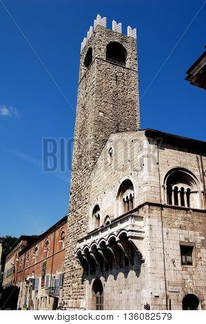 Brescia Italy - May 30, 2006: 13-17th centuries Broletto with its soaring stone 1187-1234 stone campanile the Tor del Pegol in the Piazza del Duomo