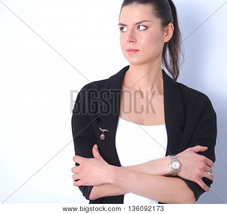 A young woman standing, isolated on graybackground
