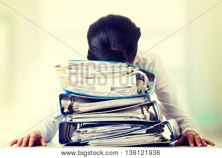 To much work to do. Sad woman with ringbinders