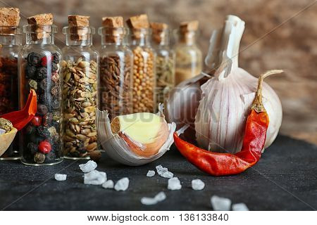 Assorted dry spices in glass bottles, close up