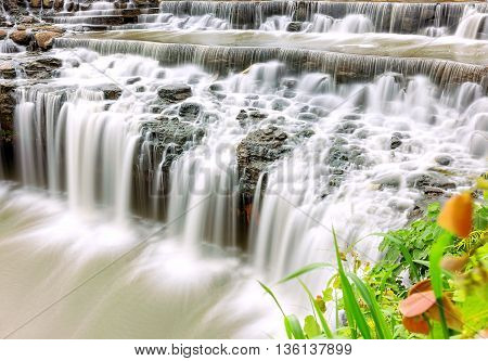 Multistage Waterfall cliff side with a beautiful soft silk stream to watch, relax in nature
