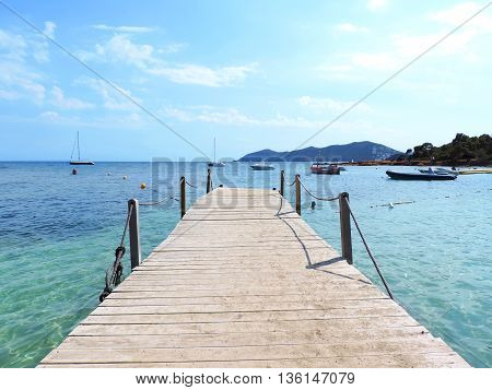Wooden Gangplank or boardwalk into the sea. Pier or jetty.