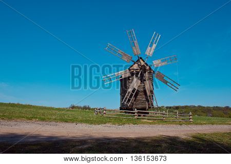 Landscape with old windmill next to the road in the village Pirogovo. Ukraine. Eastern Europe.