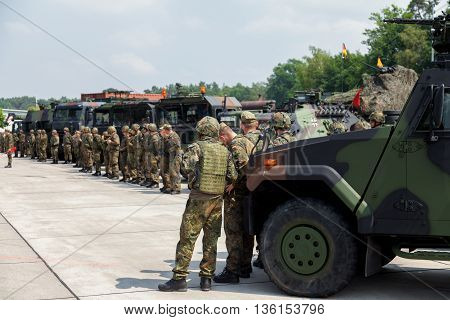 BURG / GERMANY - JUNE 25 2016: german soldiers stands on army convoy at open day in barrack burg / germany on june 25 2016
