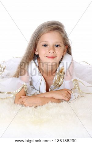 beautiful little girl lying on tummy and smiling on white background isolated
