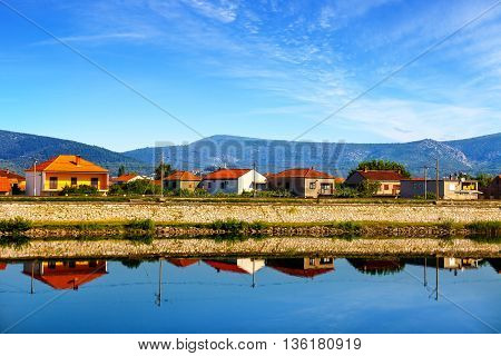 Rows of houses along the Neretva river.
