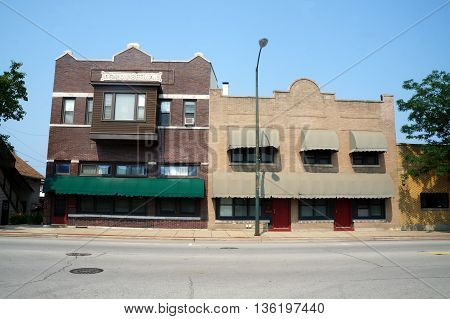 JOLIET, ILLINOIS / UNITED STATES - JUNE 30, 2015: Two historic brick buildings--one, the Simon Setina Building, constructed in 1916, and the other built in 1927--stand side by side in downtown Joliet.